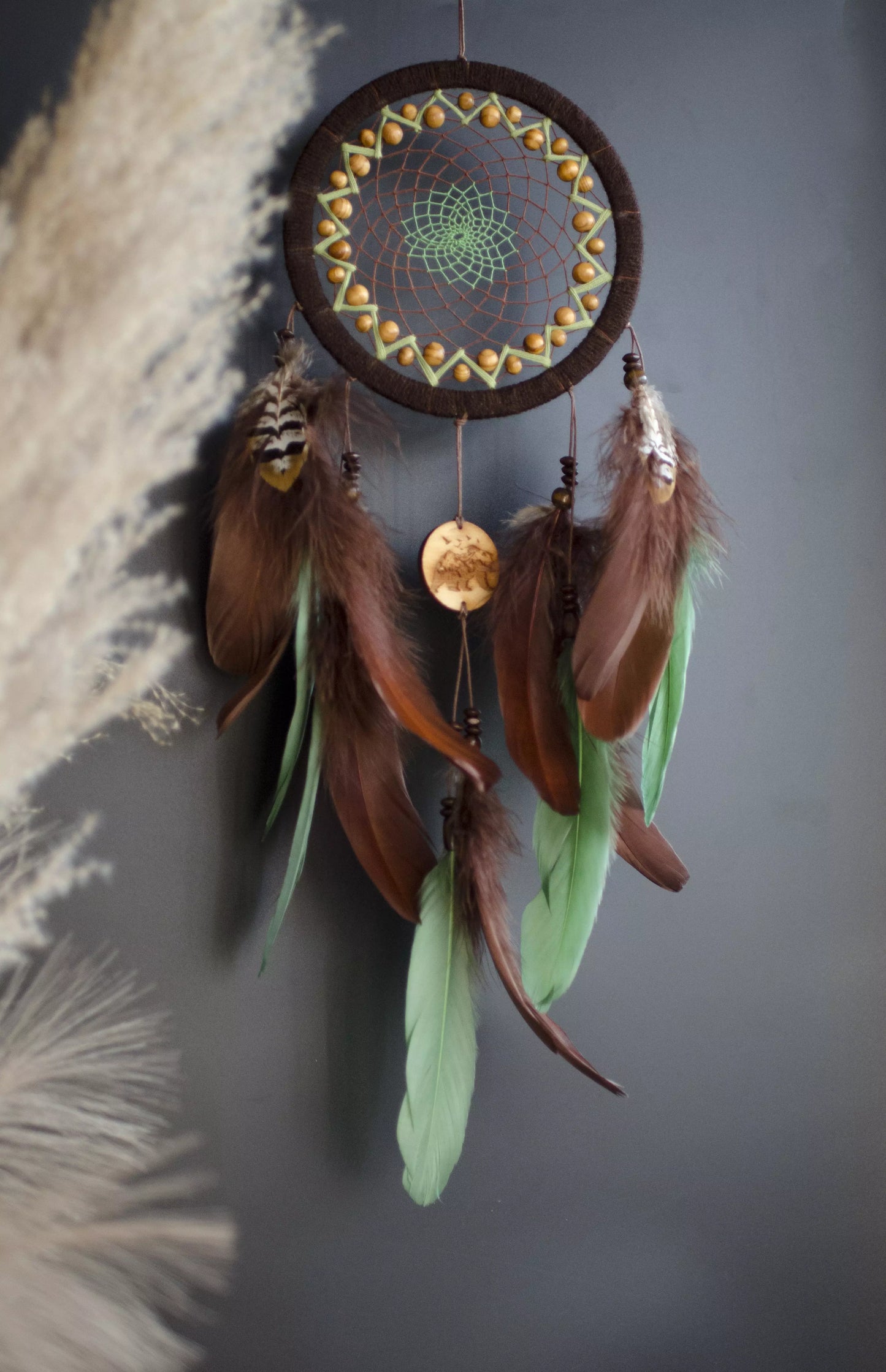 Handmade dream catcher with bear totem, rustic brown tones, feathers, and natural textures. Boho wall hanging for nature lovers and spiritual protection.