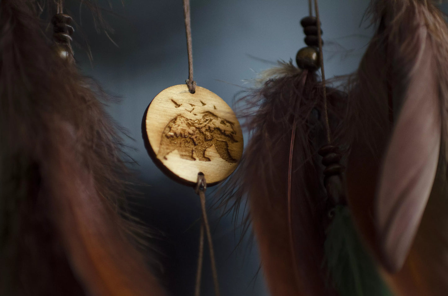 Handmade dream catcher with bear totem, rustic brown tones, feathers, and natural textures. Boho wall hanging for nature lovers and spiritual protection.