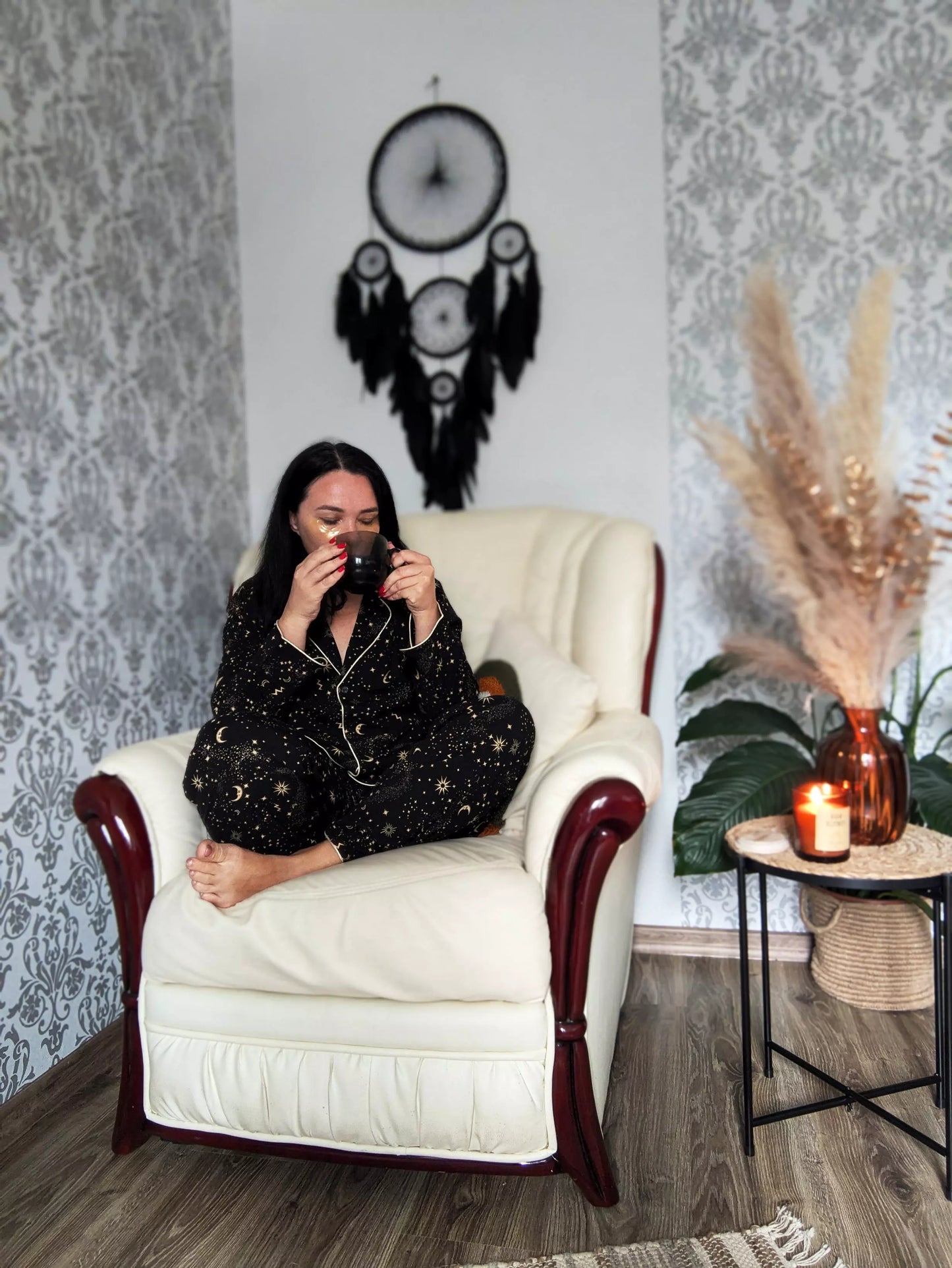 Large black multi-ring dreamcatcher featuring intricate woven web and cascading black feathers. Handcrafted boho and gothic wall decor, perfect for adding a statement piece to bedrooms or living rooms. Measures approximately 40 inches in height.