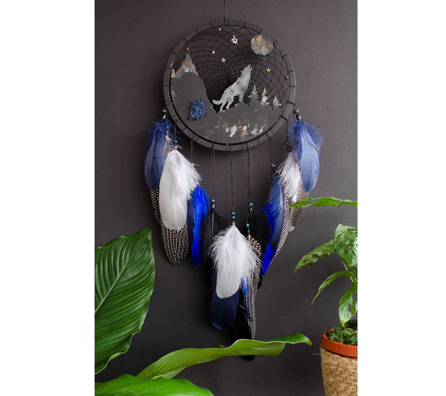 Handcrafted large black and blue wolf totem dreamcatcher with wooden wolf base, feathers, and webbing. Symbol of strength and guidance, perfect for nature-inspired space