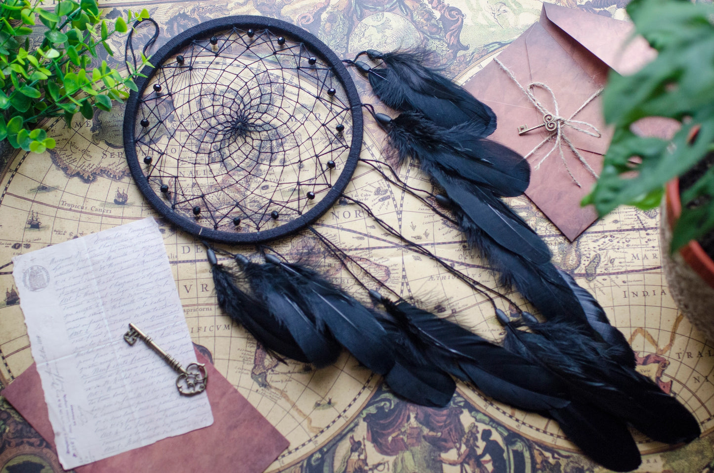 Handmade dreamcatcher with intricate web design, available in white or black, featuring hanging elements and two size options—standard and XL—perfect for boho or spiritual home decor.