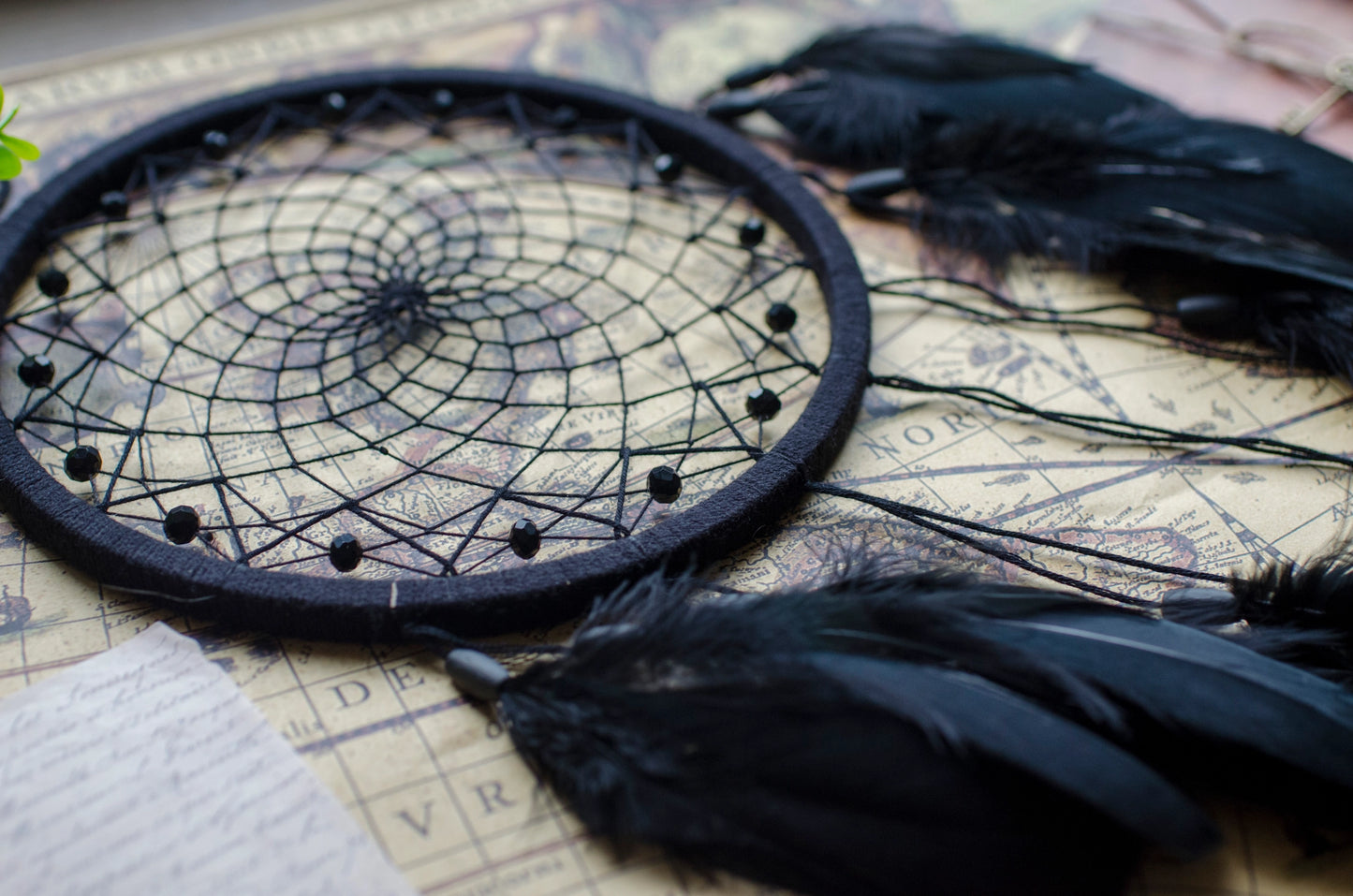 Handmade dreamcatcher with intricate web design, available in white or black, featuring hanging elements and two size options—standard and XL—perfect for boho or spiritual home decor.
