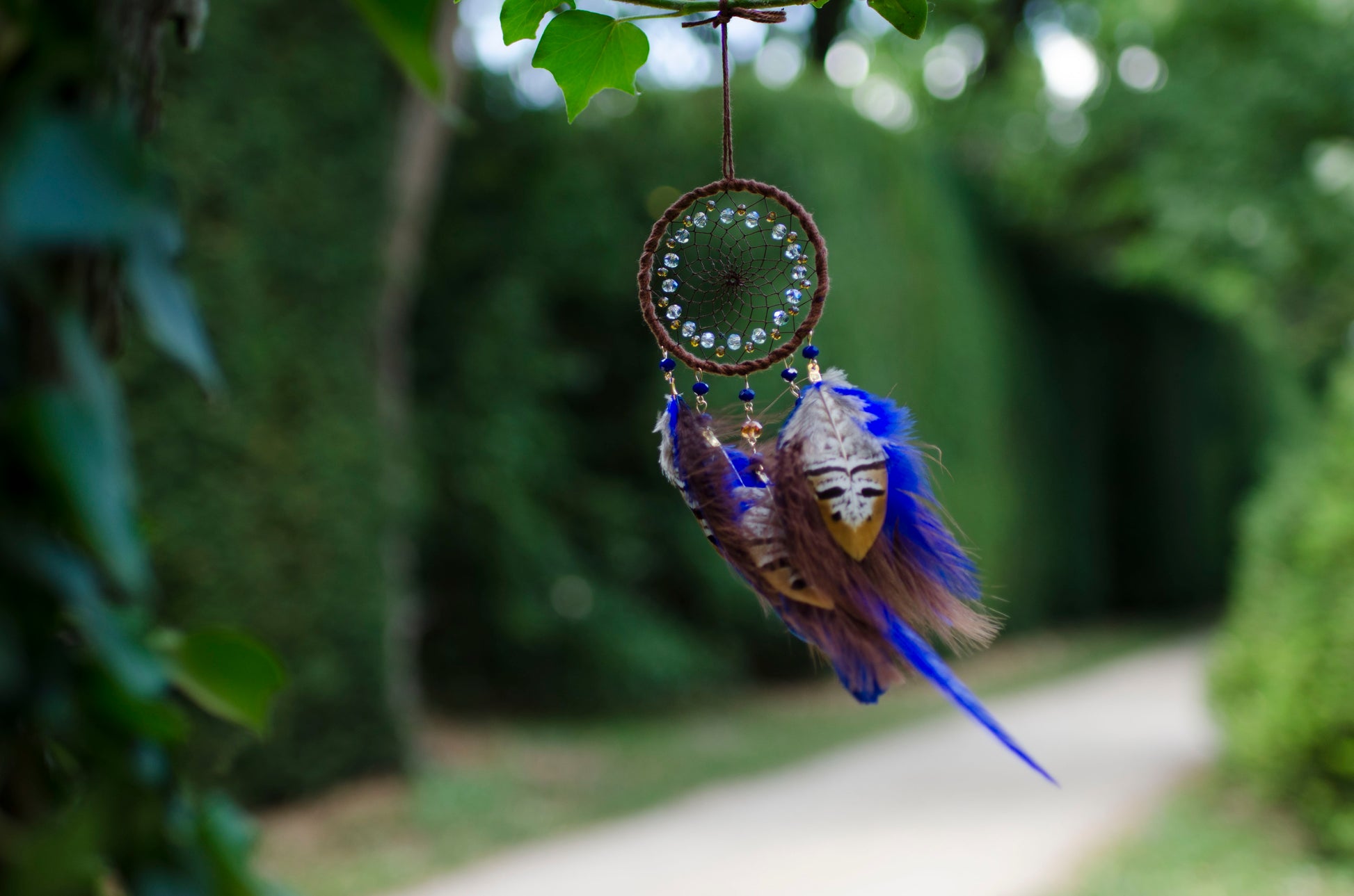 Small dreamcatcher with brown and blue feathers - car rearview mirror size