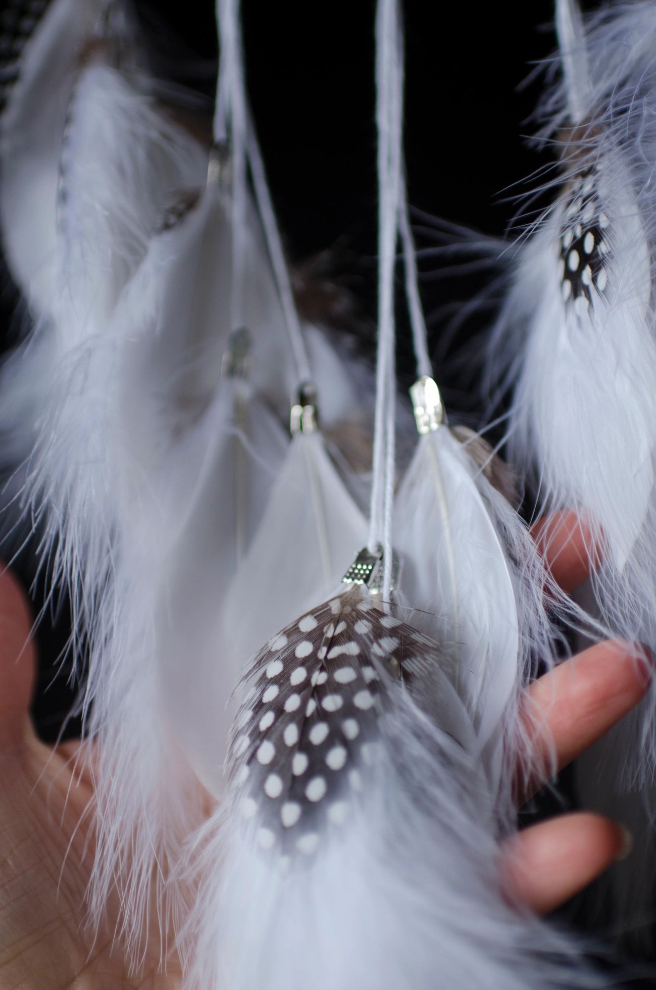 Traditional dreamcatcher with natural white feathers