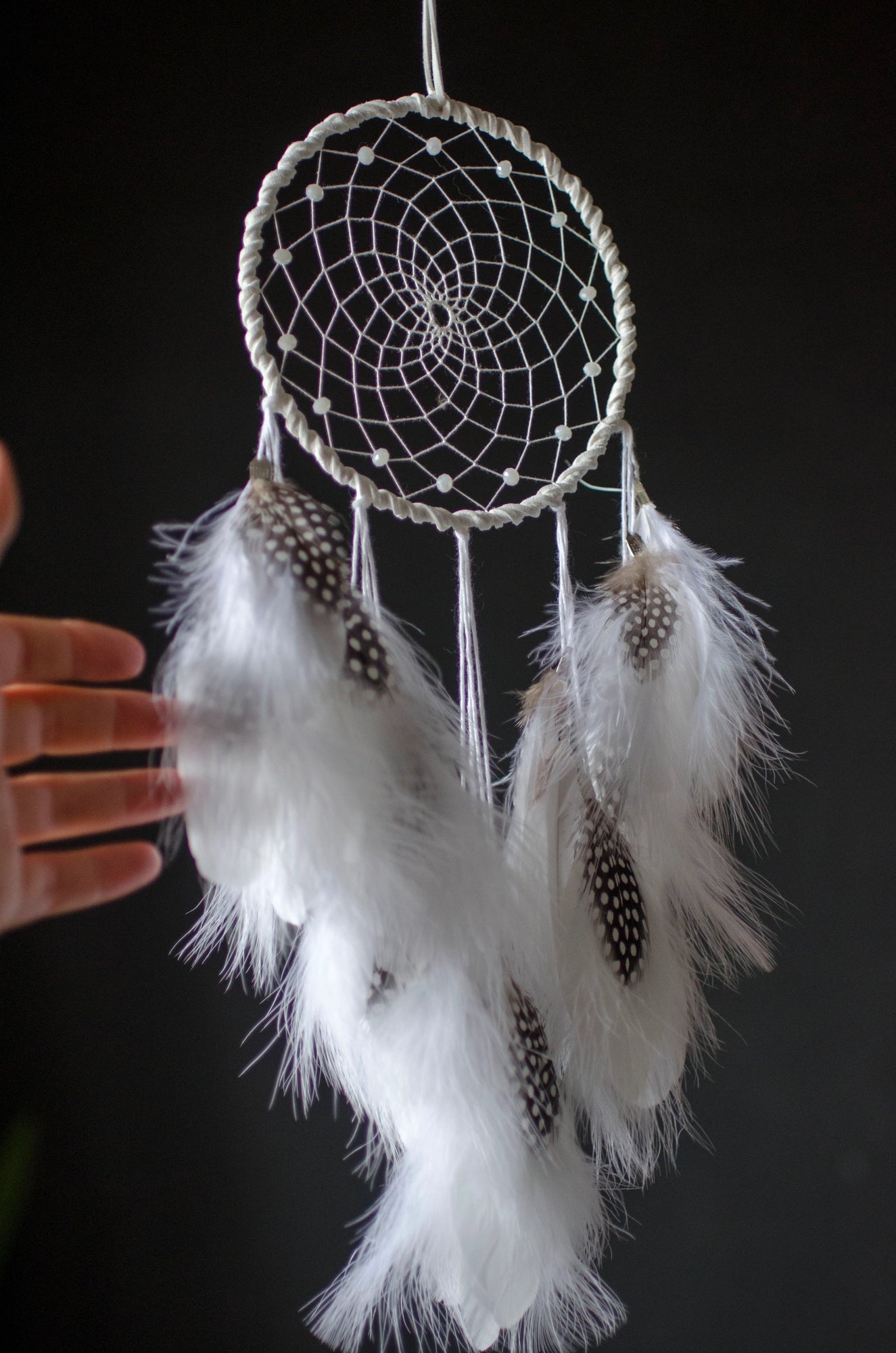 Traditional dreamcatcher with natural white feathers