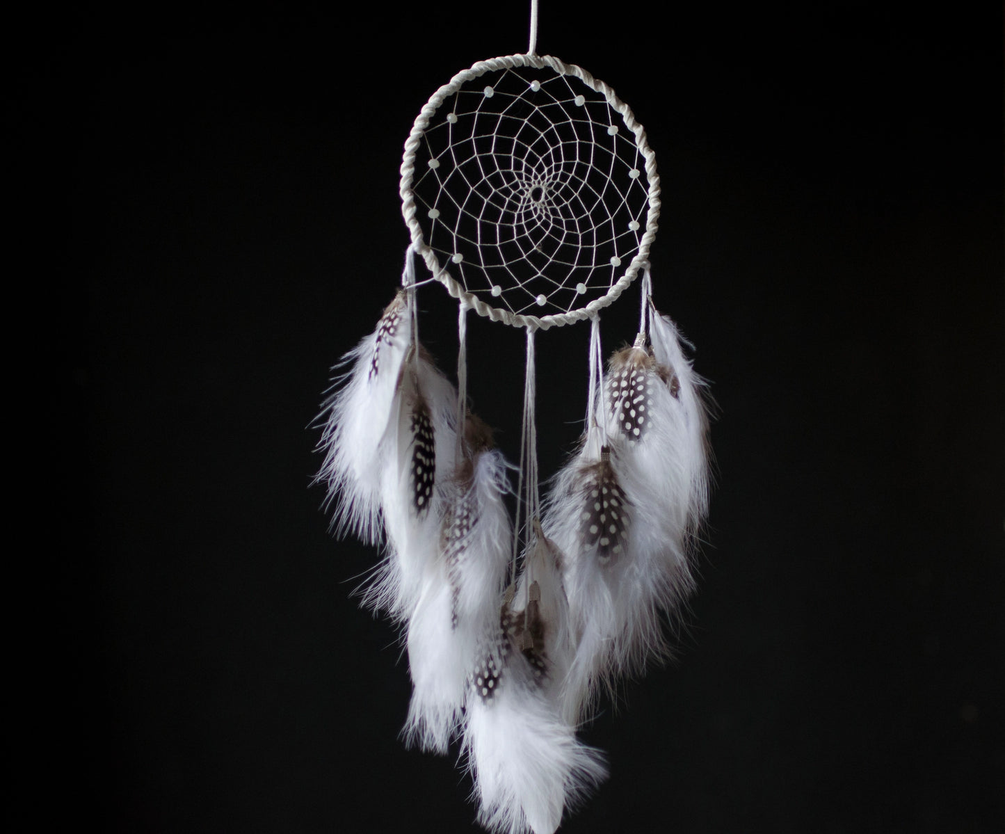 Traditional dreamcatcher with natural white feathers