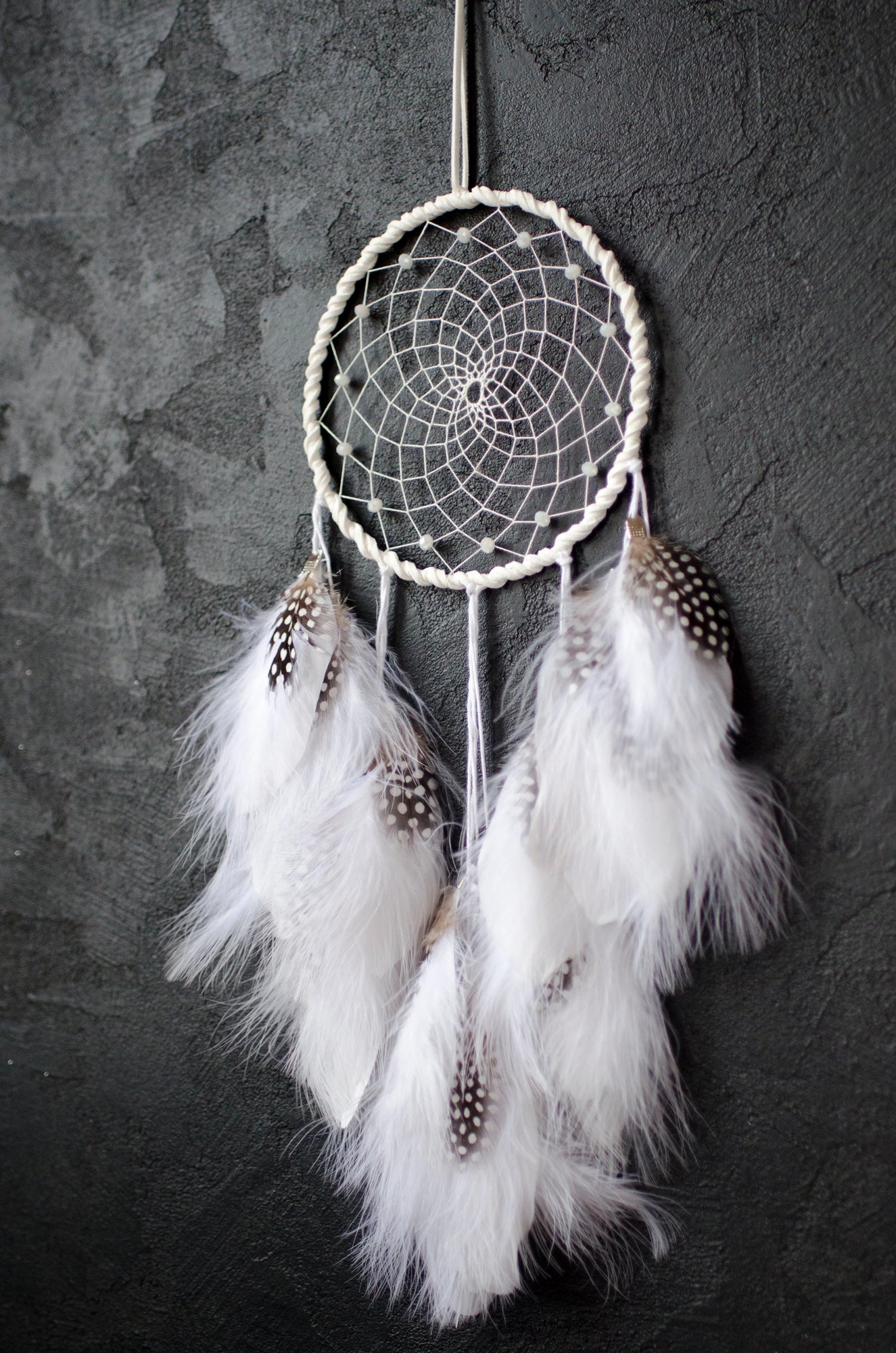 Traditional dreamcatcher with natural white feathers