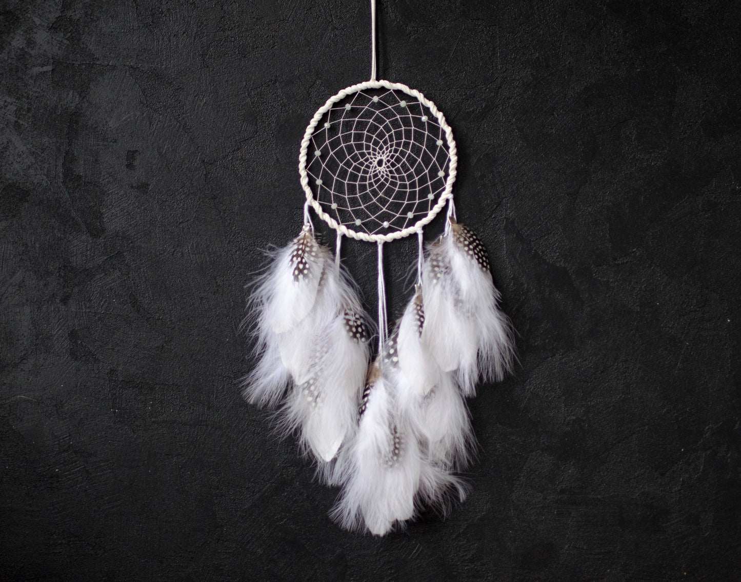 Traditional dreamcatcher with natural white feathers