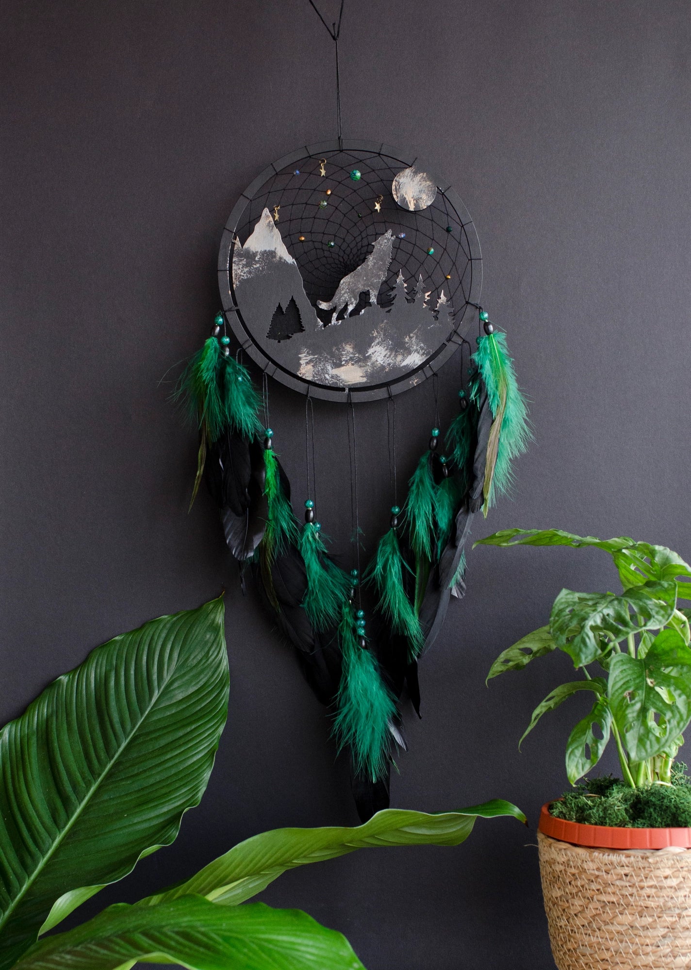 Handcrafted large black and green wolf totem dreamcatcher with wooden wolf base, feathers, and webbing. Symbol of strength and guidance, perfect for nature-inspired spaces.