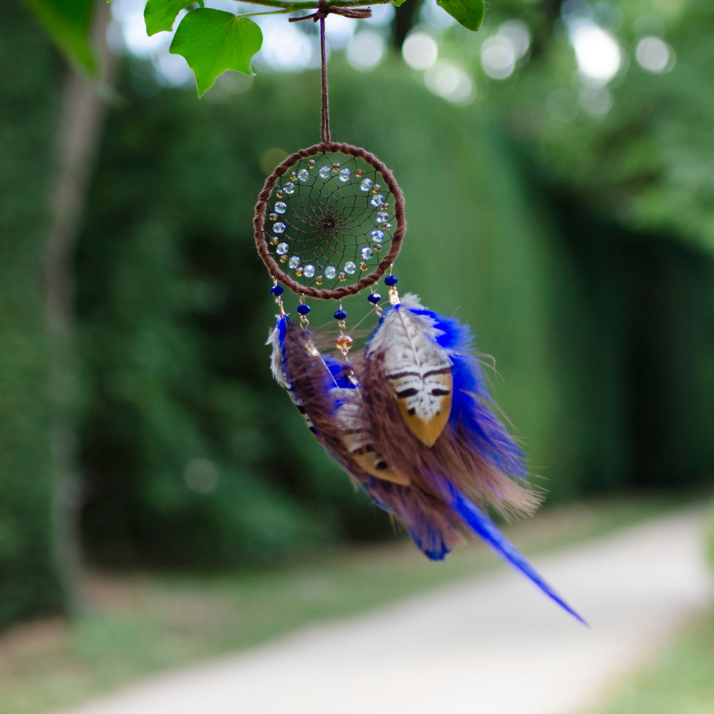 Small dreamcatcher with brown and blue feathers - car rearview mirror size