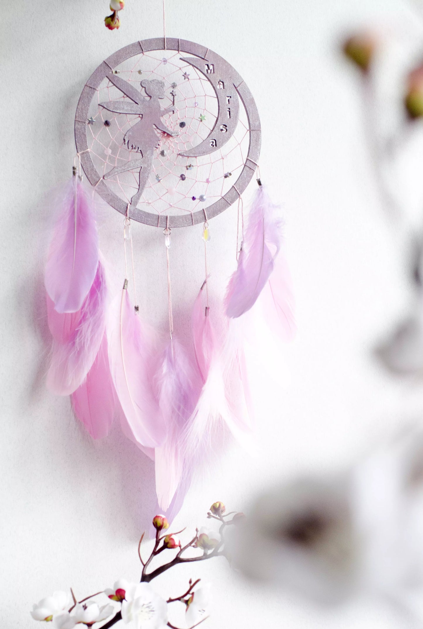 A personalized pink fairy-themed dreamcatcher with soft feathers and a custom name option. The delicate fairy design is woven into the web, making it a magical and unique wall decor piece for children's rooms or nurseries.