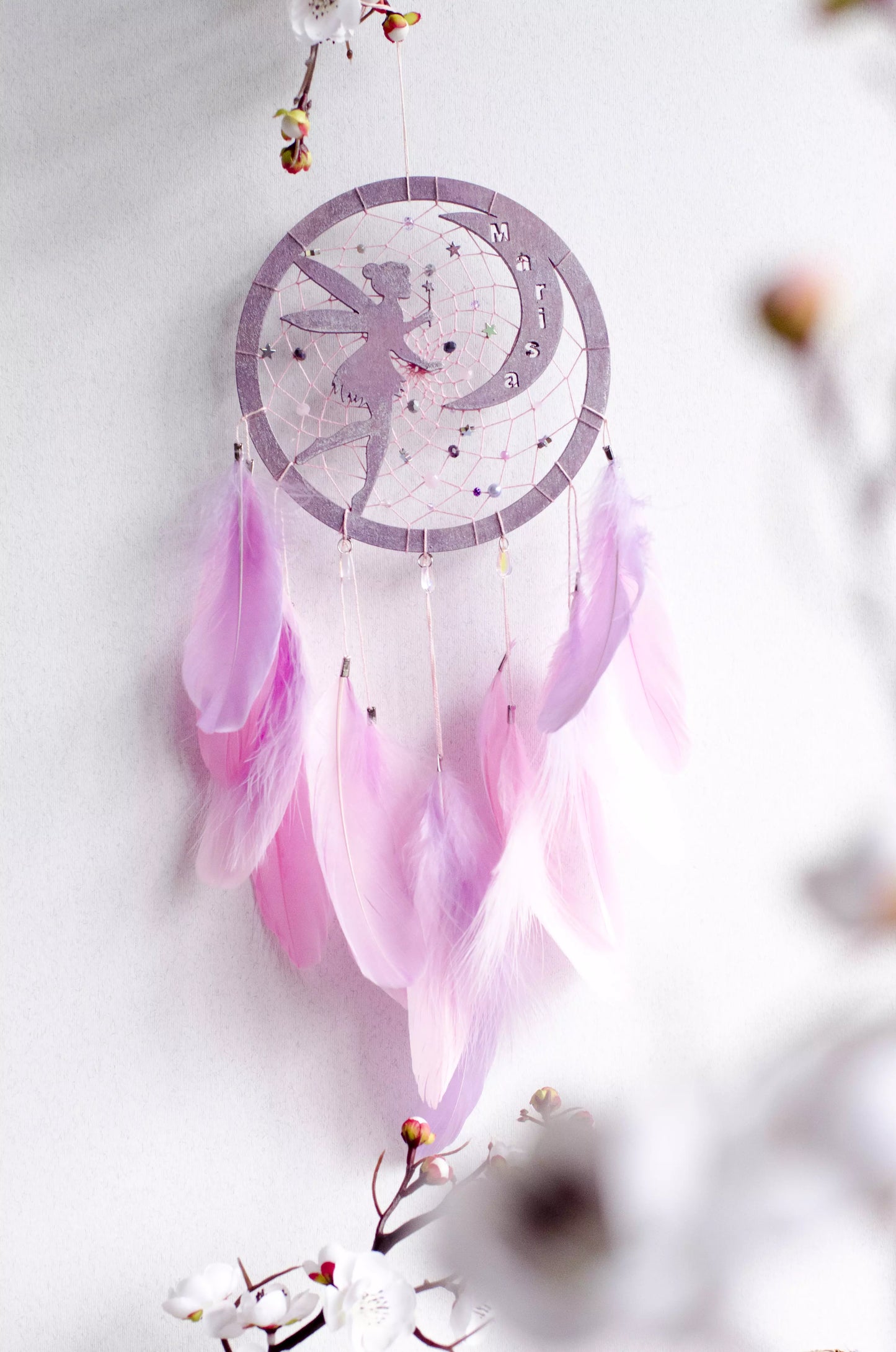 A personalized pink fairy-themed dreamcatcher with soft feathers and a custom name option. The delicate fairy design is woven into the web, making it a magical and unique wall decor piece for children's rooms or nurseries.