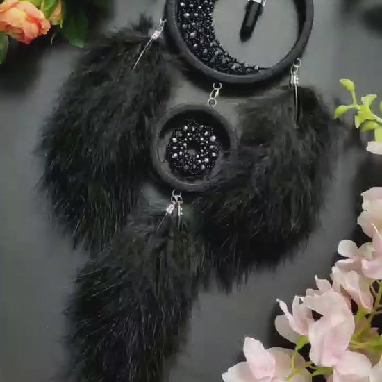 Handmade black crescent moon dreamcatcher adorned with black aventurine crystals, black beads, and soft black feathers, designed for boho and gothic decor, spiritual protection, and mystical ambiance in any space.