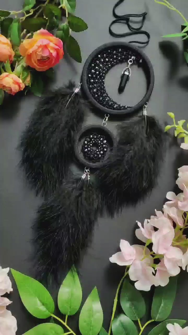 Handmade black crescent moon dreamcatcher adorned with black aventurine crystals, black beads, and soft black feathers, designed for boho and gothic decor, spiritual protection, and mystical ambiance in any space.