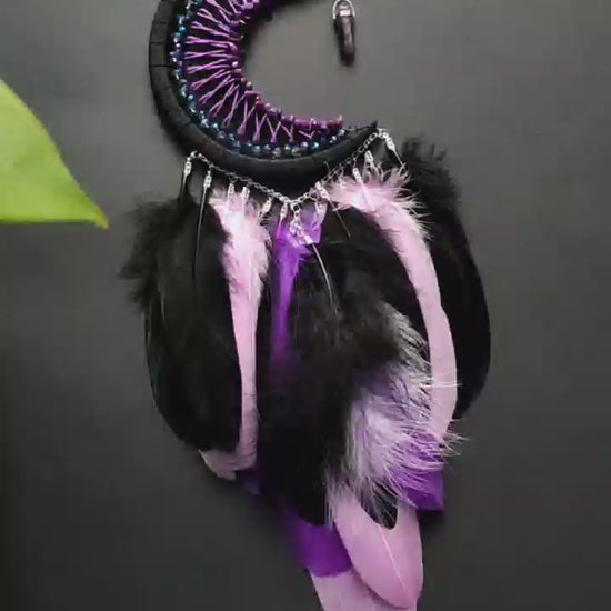 Handmade purple triple moon dreamcatcher set featuring intricate moon phase designs, adorned with purple and black feathers, amethyst crystal accents, and chain details. Perfect for celestial-inspired boho wall decor or spiritual meditation spaces.