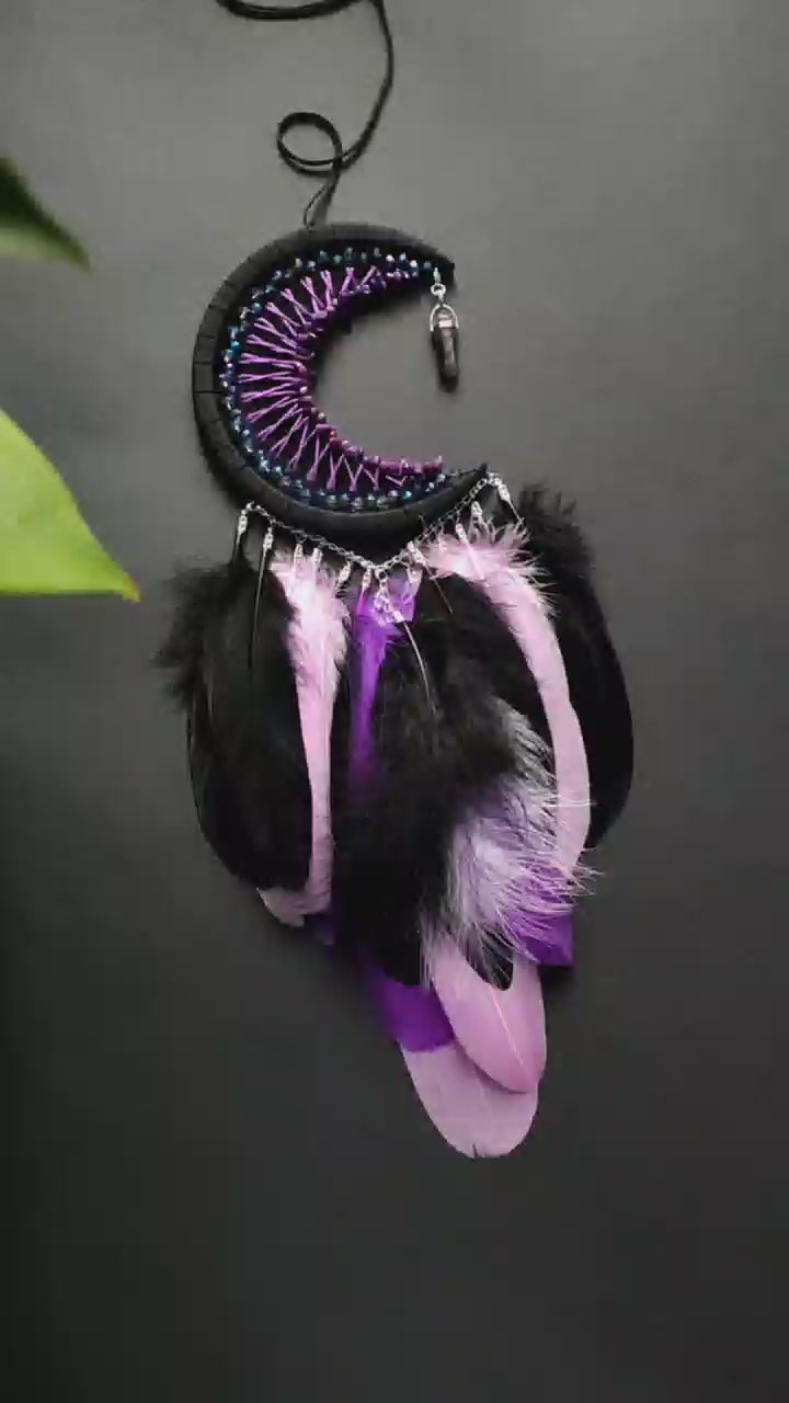 Handmade purple triple moon dreamcatcher set featuring intricate moon phase designs, adorned with purple and black feathers, amethyst crystal accents, and chain details. Perfect for celestial-inspired boho wall decor or spiritual meditation spaces.