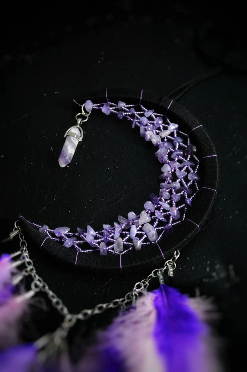 Handmade purple triple moon dreamcatcher set featuring intricate moon phase designs, adorned with purple and black feathers, amethyst crystal accents, and chain details. Perfect for celestial-inspired boho wall decor or spiritual meditation spaces.