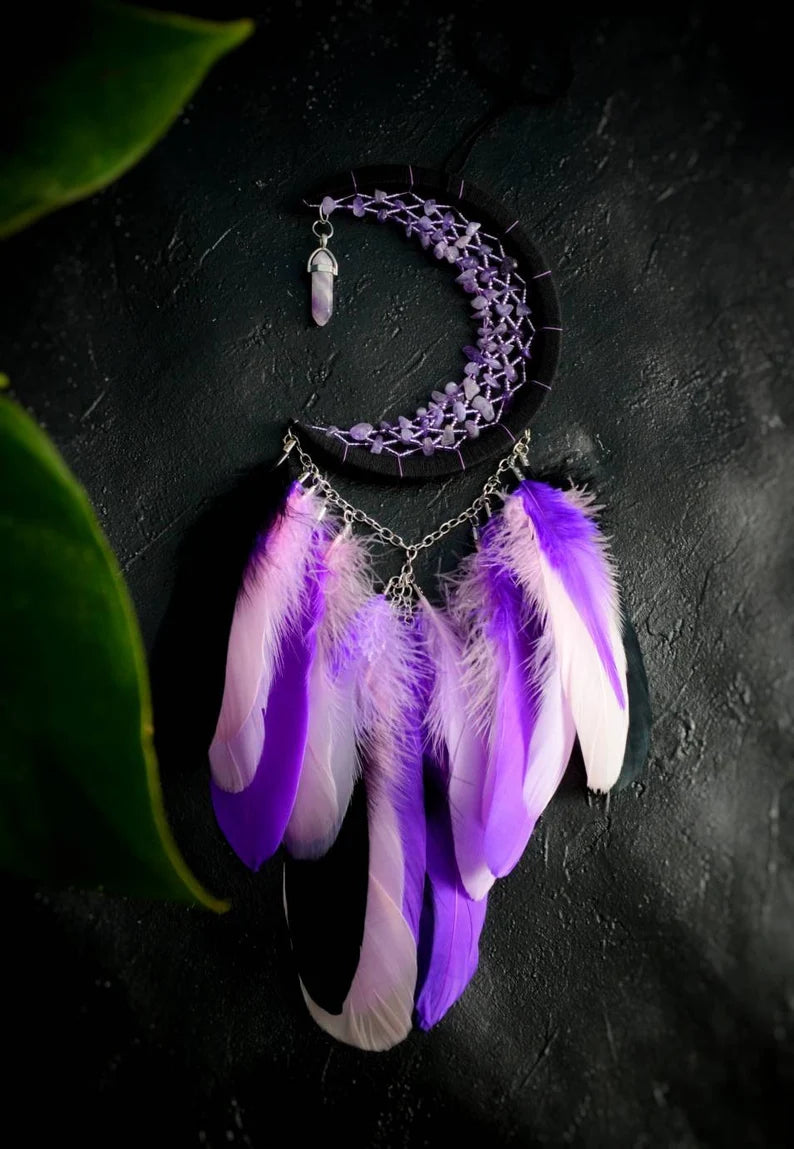 Handmade purple triple moon dreamcatcher set featuring intricate moon phase designs, adorned with purple and black feathers, amethyst crystal accents, and chain details. Perfect for celestial-inspired boho wall decor or spiritual meditation spaces.