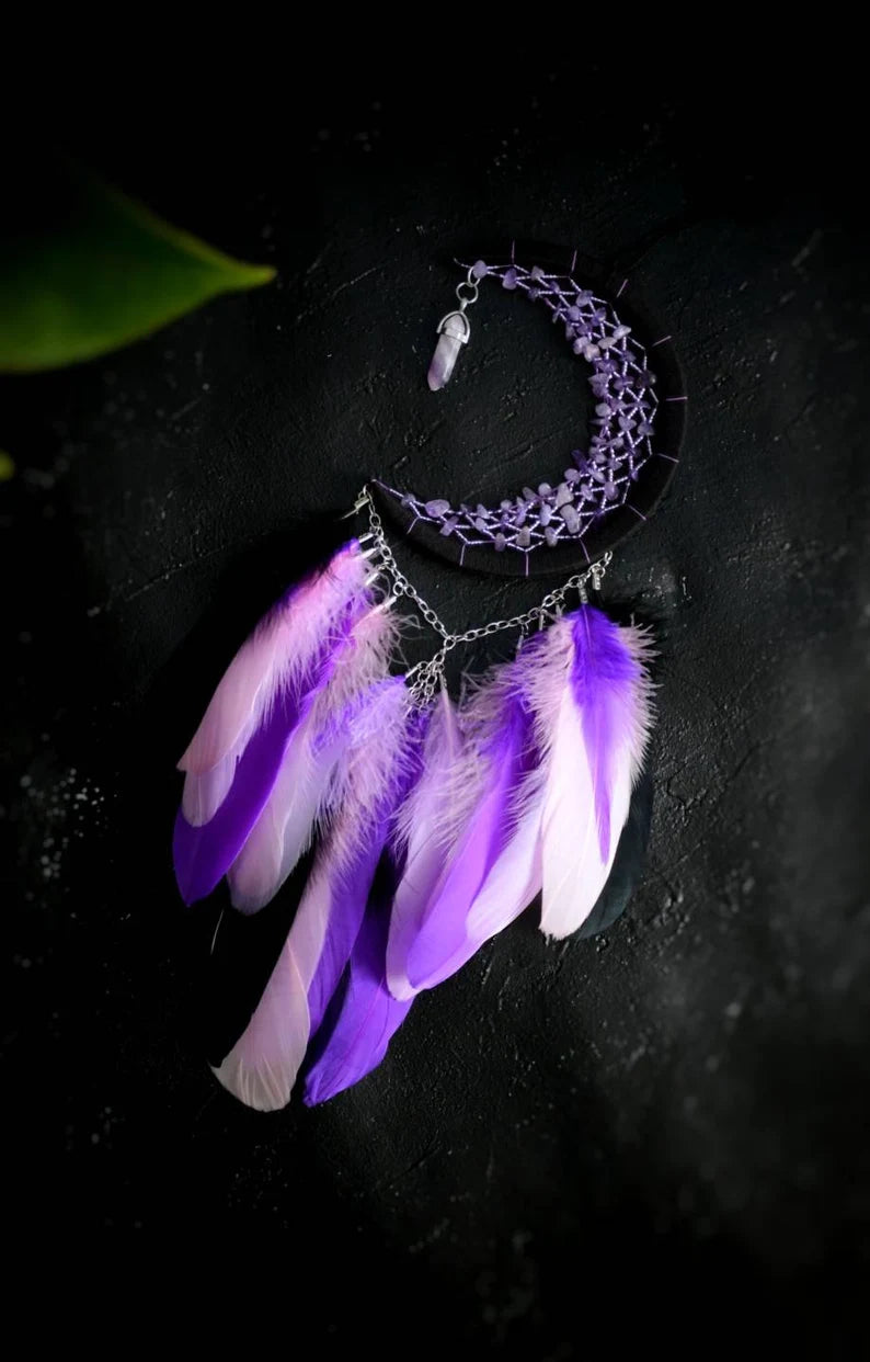 Handmade purple triple moon dreamcatcher set featuring intricate moon phase designs, adorned with purple and black feathers, amethyst crystal accents, and chain details. Perfect for celestial-inspired boho wall decor or spiritual meditation spaces.