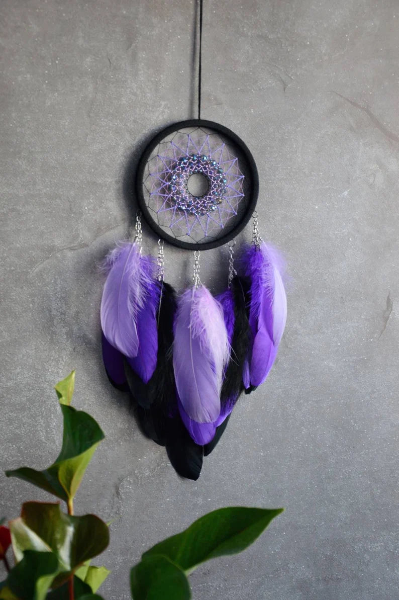 Handmade purple triple moon dreamcatcher set featuring intricate moon phase designs, adorned with purple and black feathers, amethyst crystal accents, and chain details. Perfect for celestial-inspired boho wall decor or spiritual meditation spaces.