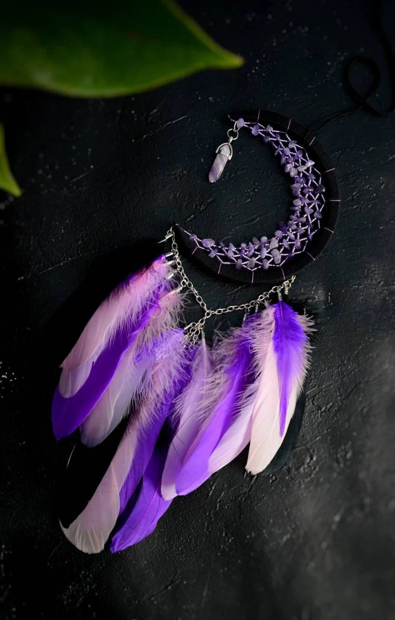 Handmade purple triple moon dreamcatcher set featuring intricate moon phase designs, adorned with purple and black feathers, amethyst crystal accents, and chain details. Perfect for celestial-inspired boho wall decor or spiritual meditation spaces.