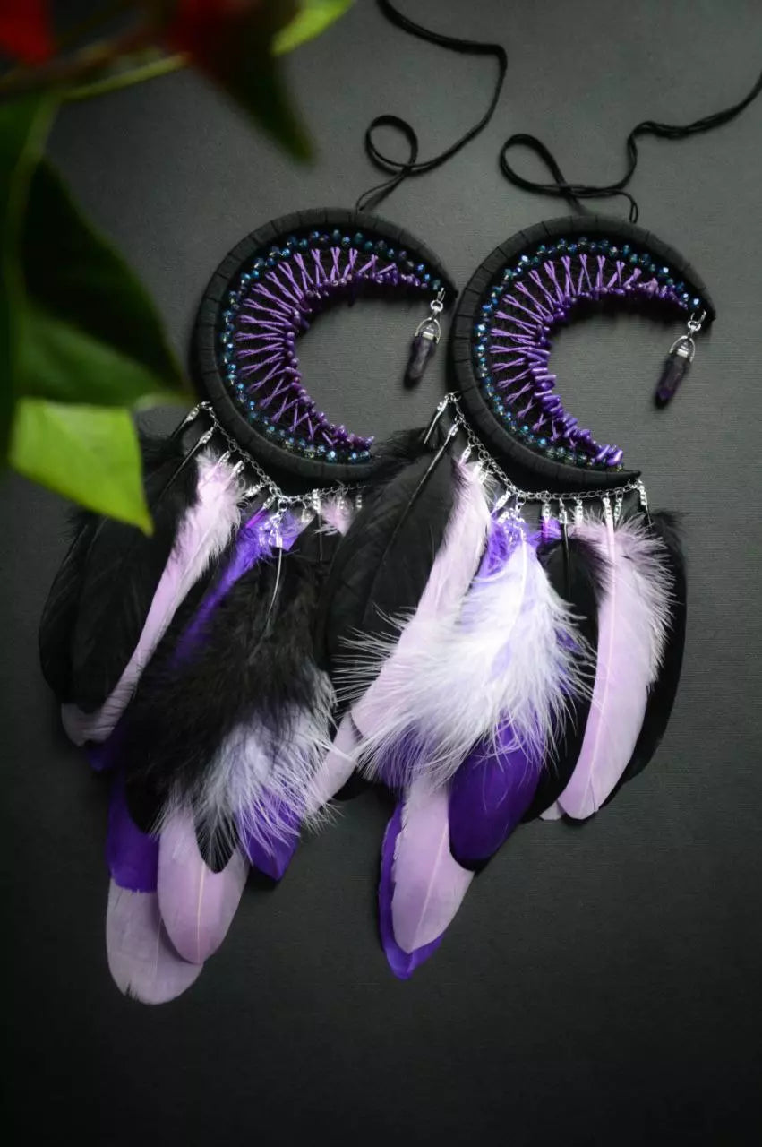 Handmade purple triple moon dreamcatcher set featuring intricate moon phase designs, adorned with purple and black feathers, amethyst crystal accents, and chain details. Perfect for celestial-inspired boho wall decor or spiritual meditation spaces.