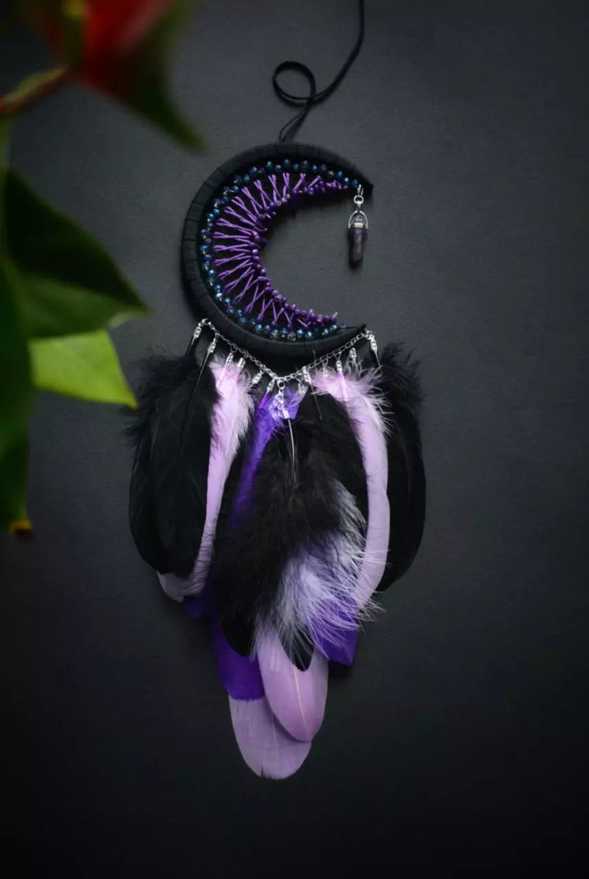 Handmade purple triple moon dreamcatcher set featuring intricate moon phase designs, adorned with purple and black feathers, amethyst crystal accents, and chain details. Perfect for celestial-inspired boho wall decor or spiritual meditation spaces.