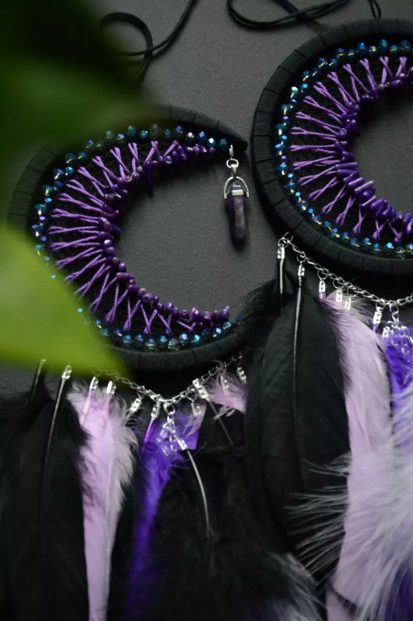 Handmade purple triple moon dreamcatcher set featuring intricate moon phase designs, adorned with purple and black feathers, amethyst crystal accents, and chain details. Perfect for celestial-inspired boho wall decor or spiritual meditation spaces.