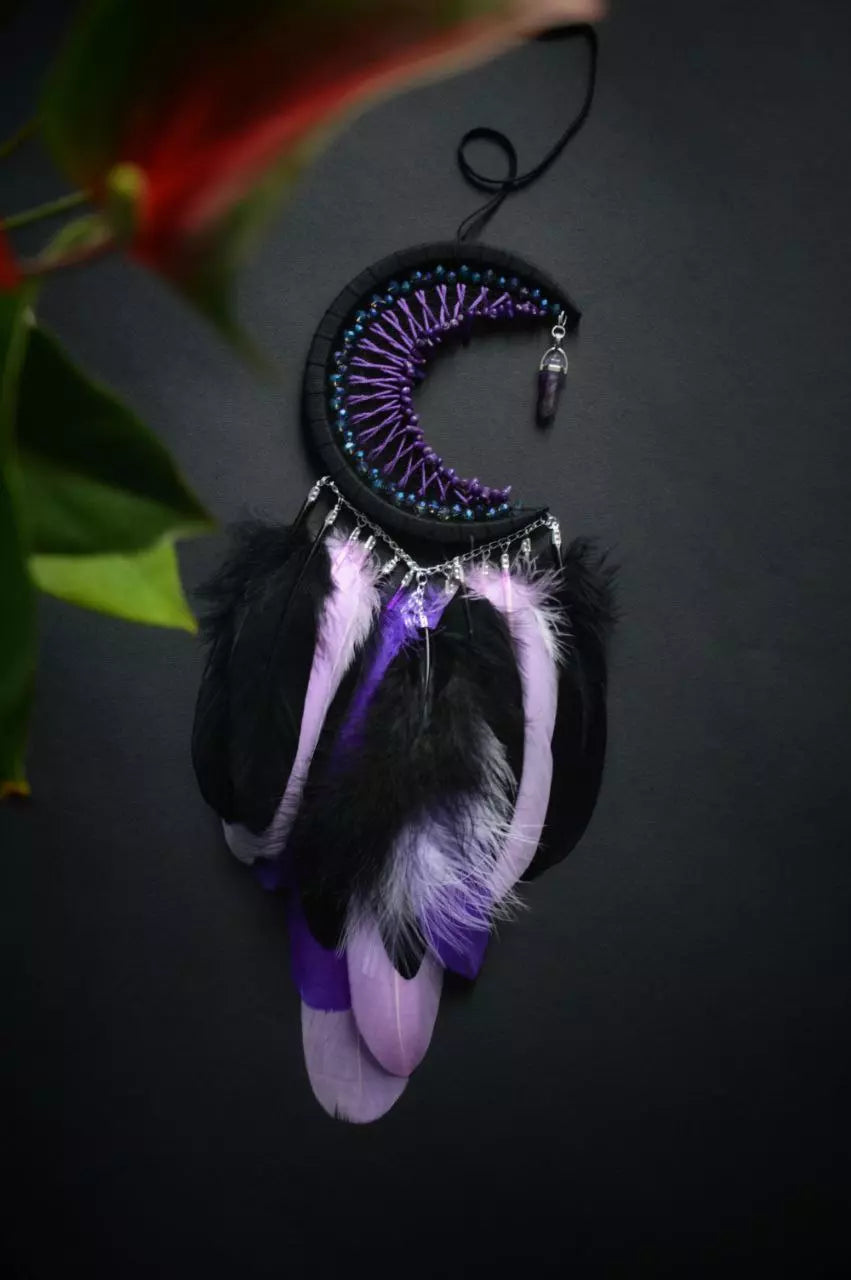 Handmade purple triple moon dreamcatcher set featuring intricate moon phase designs, adorned with purple and black feathers, amethyst crystal accents, and chain details. Perfect for celestial-inspired boho wall decor or spiritual meditation spaces.