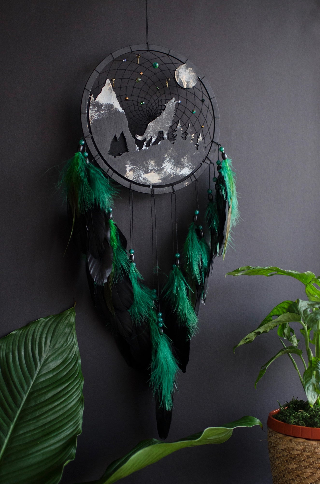 Handcrafted large black and green wolf totem dreamcatcher with wooden wolf base, feathers, and webbing. Symbol of strength and guidance, perfect for nature-inspired spaces.